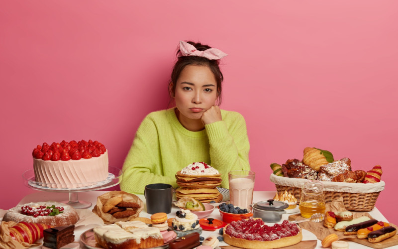 Perempuan dan aneka makanan manis. (Freepik)